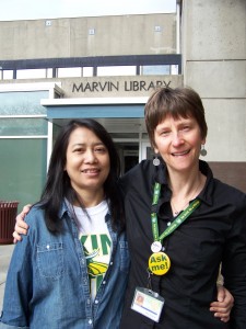 Student Aye Aye Tun and Library Senior Clerk Polly Karis, who has worked to help acclimate refugees to the college campus. 