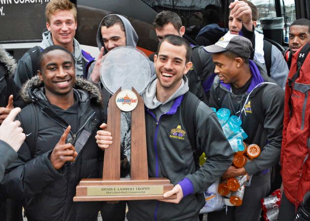 UAlbany men's basketball team with America East conference championship trophy