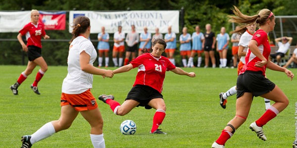 Oneonta lady soccer player kicks ball toward goal