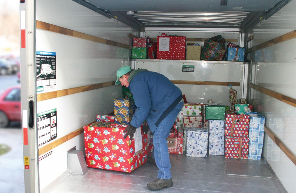 SUNY Orange County Community College Volunteer inside truck with gift boxes 