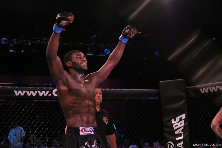 Aljamain Sterling stands with raised hands  in the octagon at Cage Fury Fighting Championships 10 in July 2011