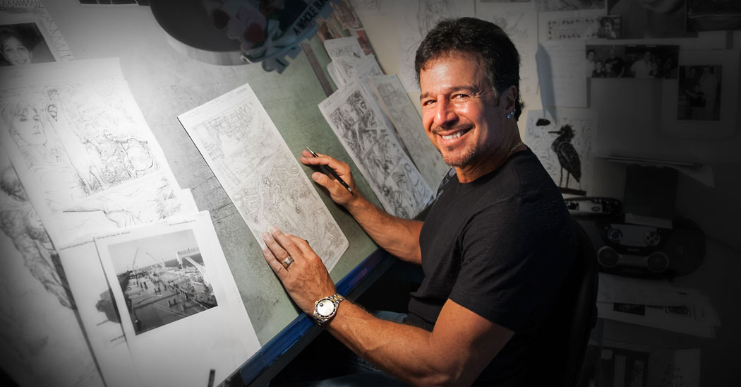 John Romita Jr, Farmingdale State College alumni, sits at a drawing table working on sketches of Superman for DC Comics.