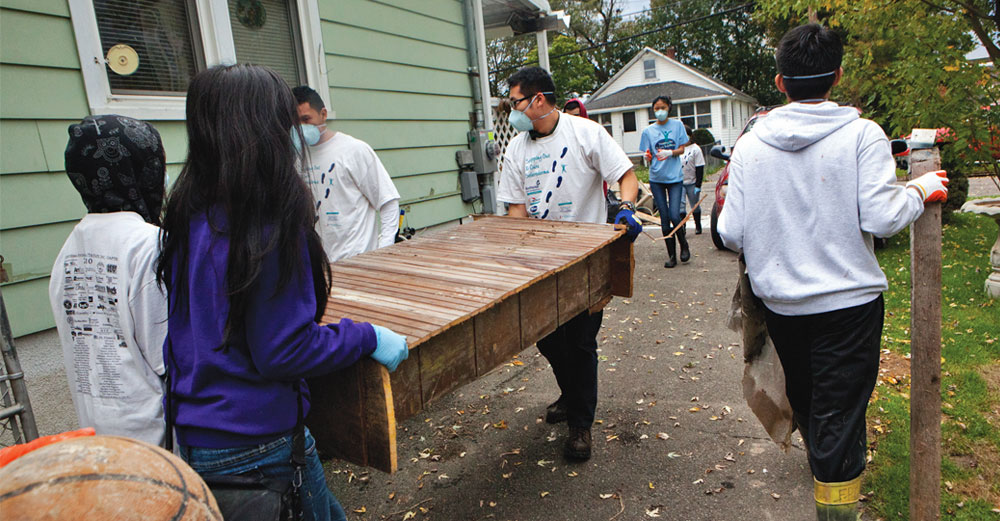 Binghamton University students doing community service by fixing a house.