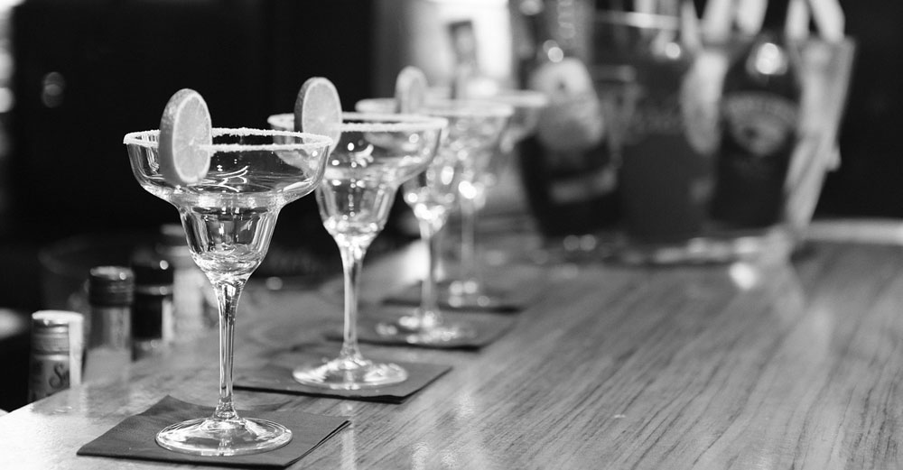 cocktail glasses on bar in black and white