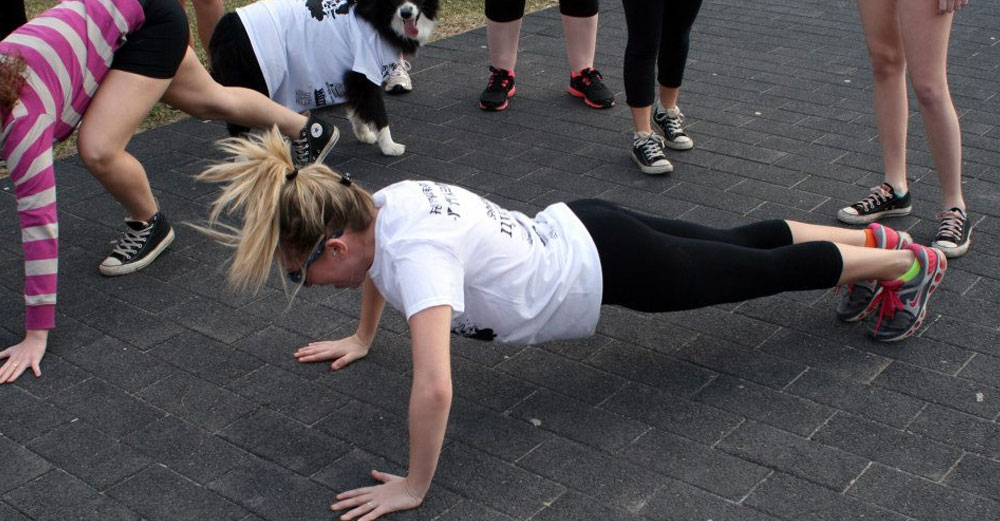 One student does push-ups while partaking in a charity fundraiser. 