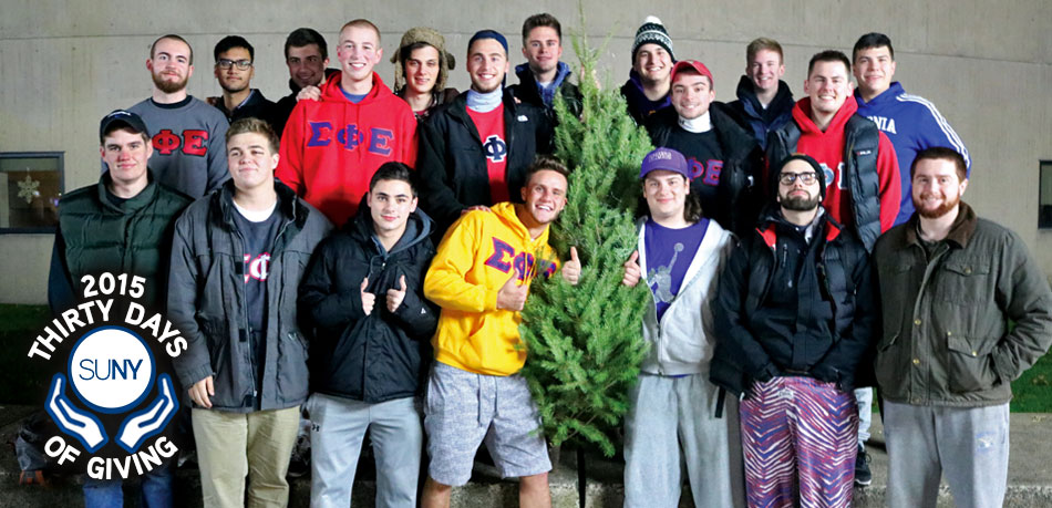 SUNY Fredonia students stand around a Christmas Tree after their annual Tree Troy for Big Brothers Big Sisters