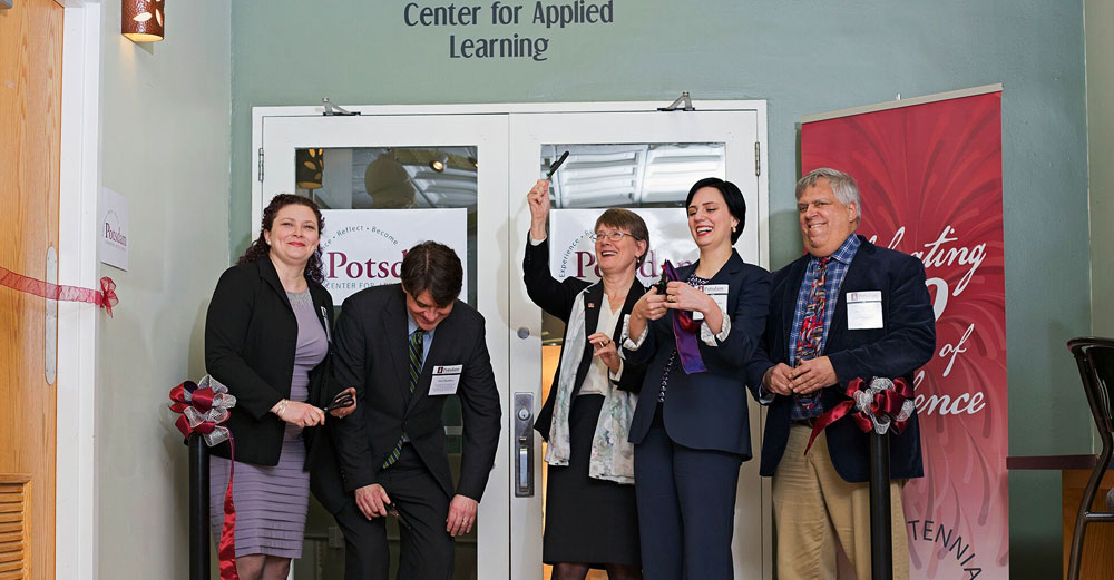 The ribbon is cut at SUNY Postdam with campus leaders and SUNY System Admin staff