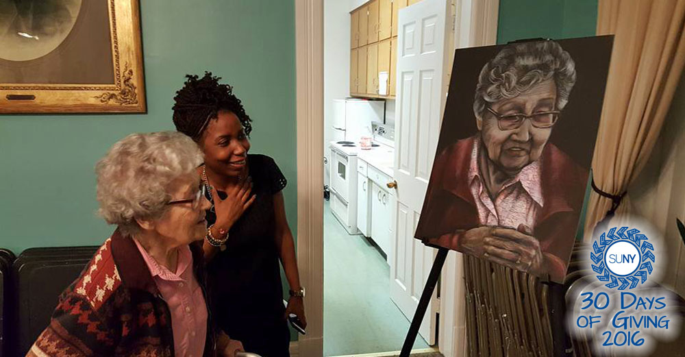 Cammie Jones, Dutchess Community College Service Learning Coordinator, looks at a painting in a senior center house with an elderly woman.