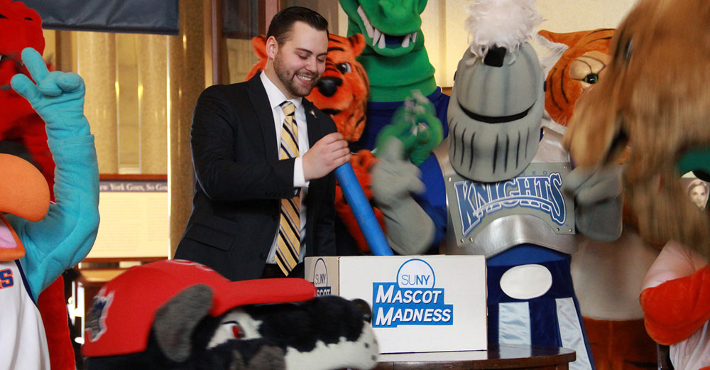 Tom Mastro pulls the lever to kick off 2016 Mascot Madness at the state capital.