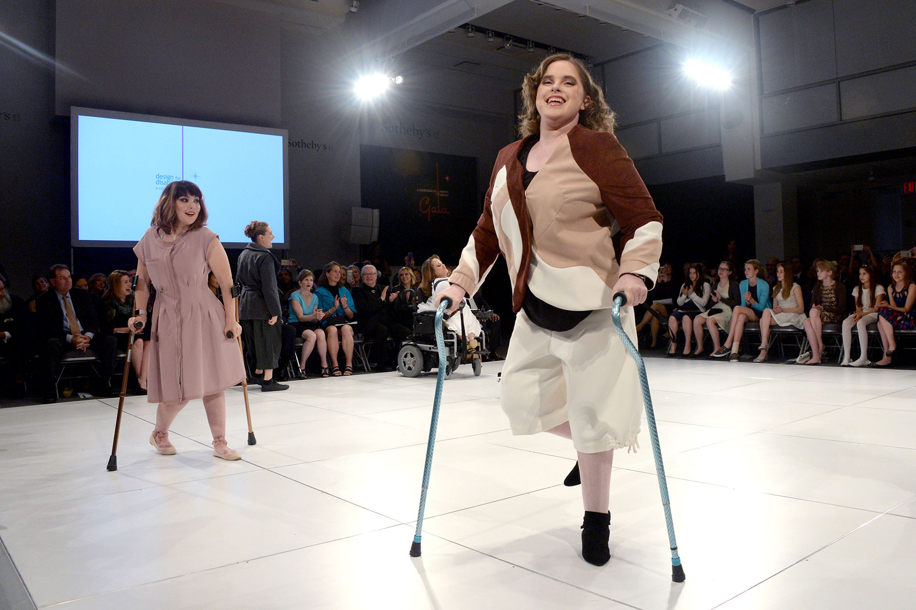Disabled women on crutches on runway at FIT fashion show.