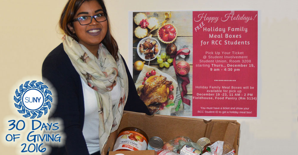 Elizabeth Perez of Student Involvement at Rockland Community College assists with distribution of holiday food boxes for students.