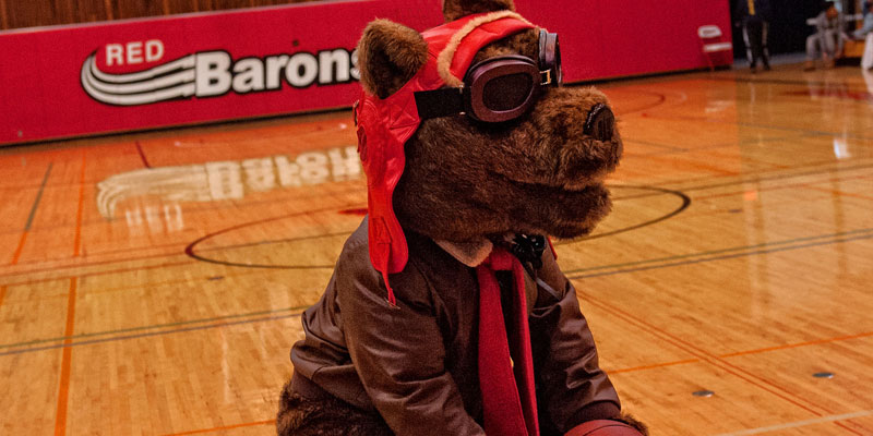 Corning Community College mascot Red Baron in basketball arena