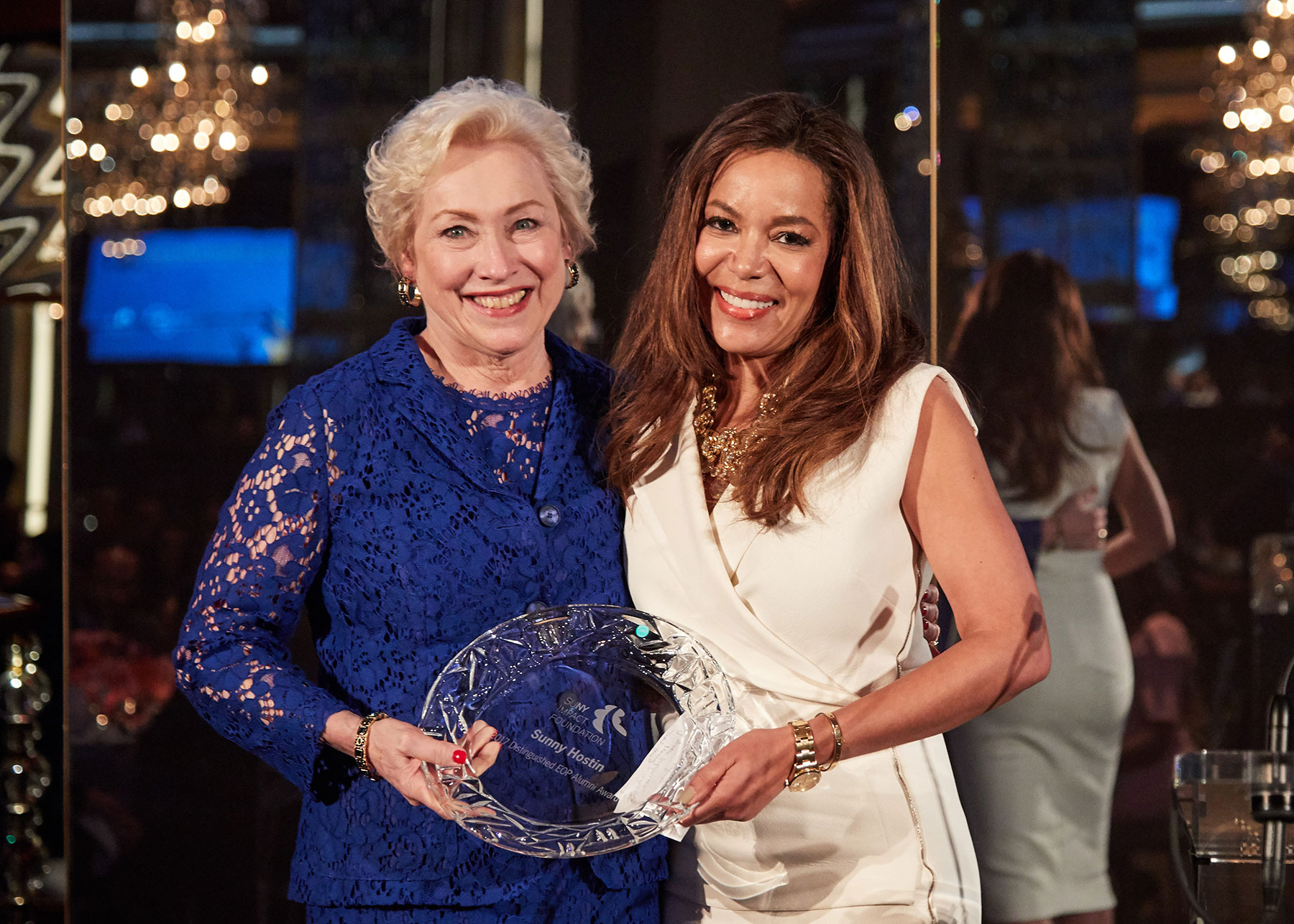SUNY chancellor Nanzy Zimpher stands with The View co-host Sunny Hostin as they hold the Distinguished EOP Alumni award. 