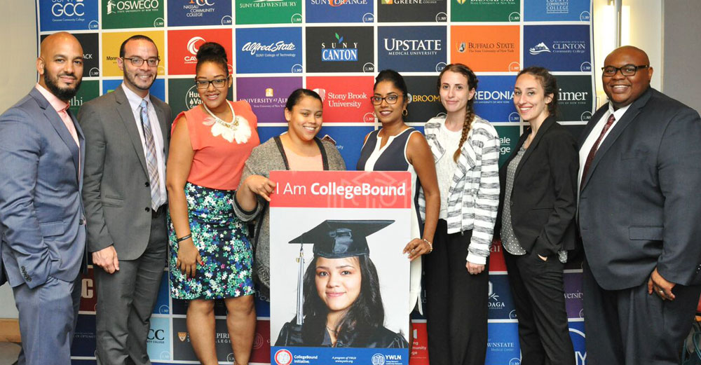 Students from the New York City area stand in front of a SUNY banner around a sign that says I Am College Bound.