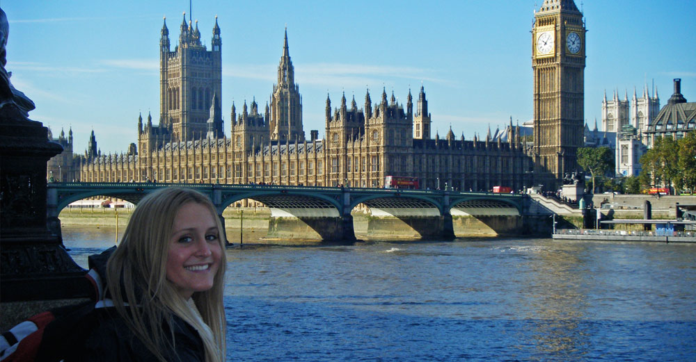 A female student sits across the River Thames from Big Ben in London.