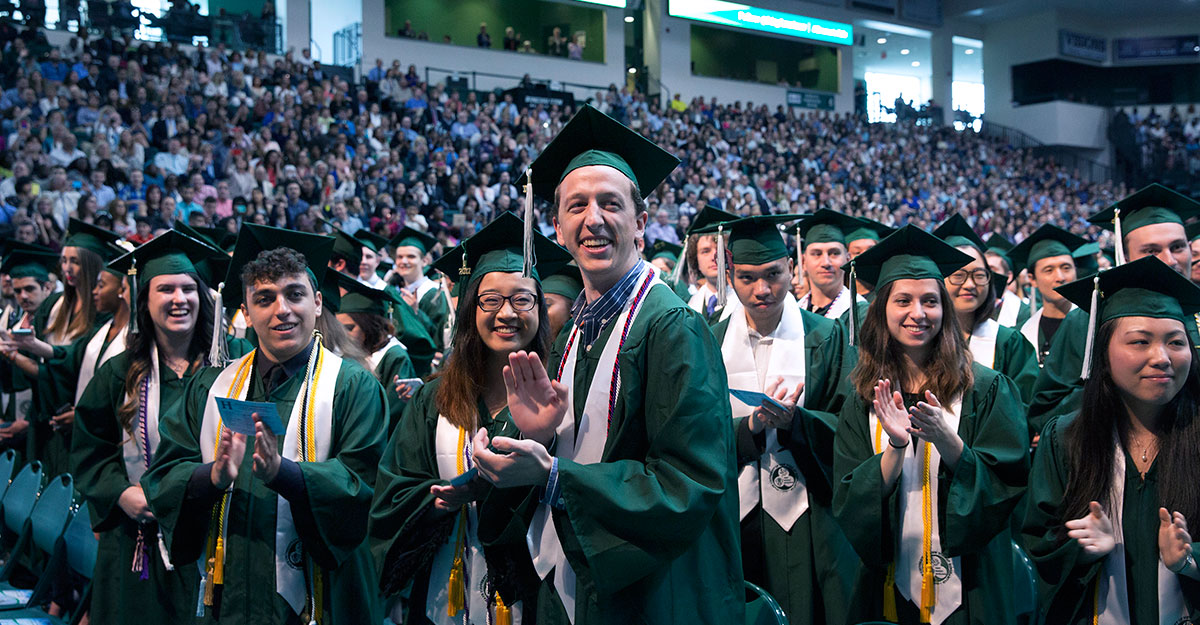 Students standing at Binghamton university commencement