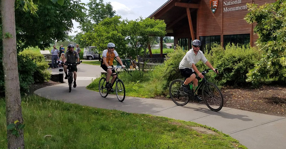 People ride bikes near the Fort Stanwix museum on the Mohawk Valley Region Path Through History.