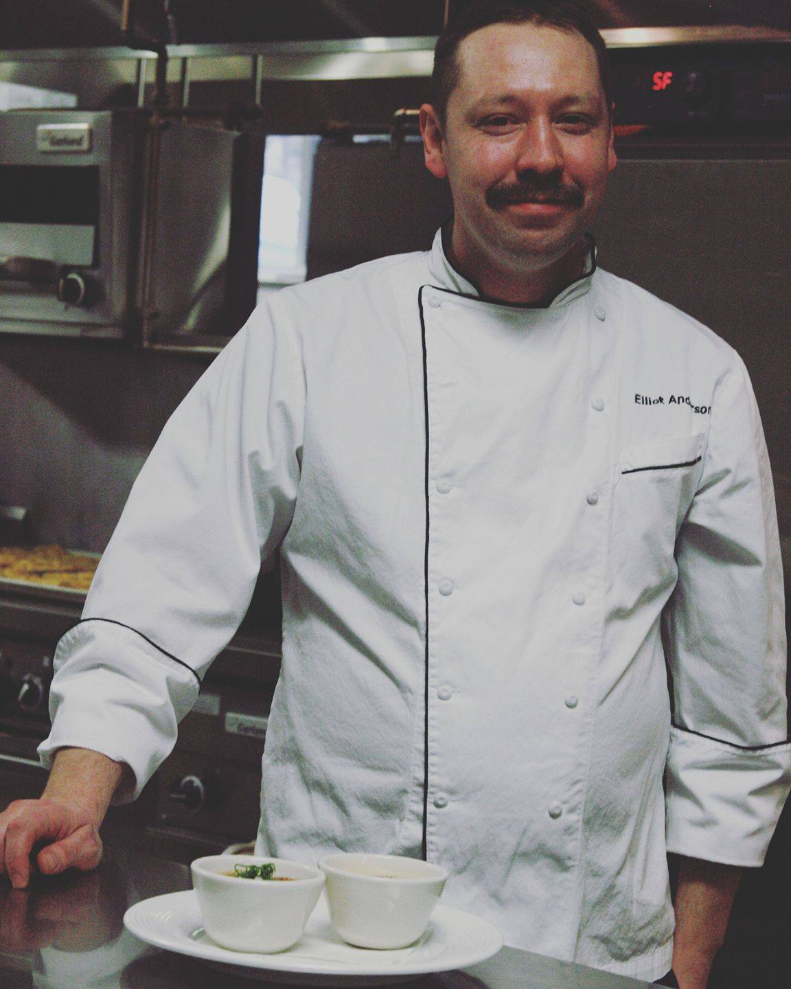 Chef Eliot Anderson of Coltivare poses in the kitchen.