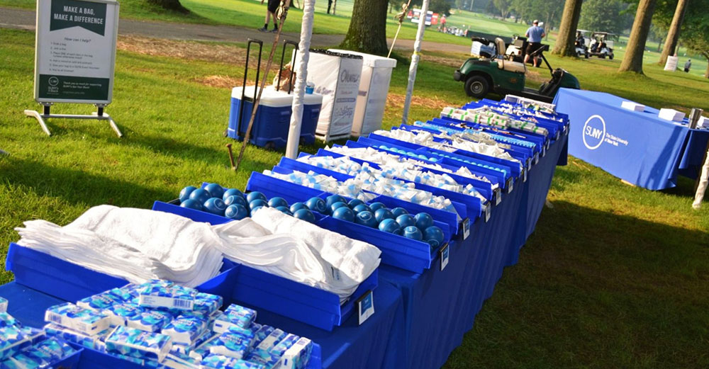 SUNY's Got Your Back goods line a table at the Dick's Sporting Goods Open in Endicott, NY.