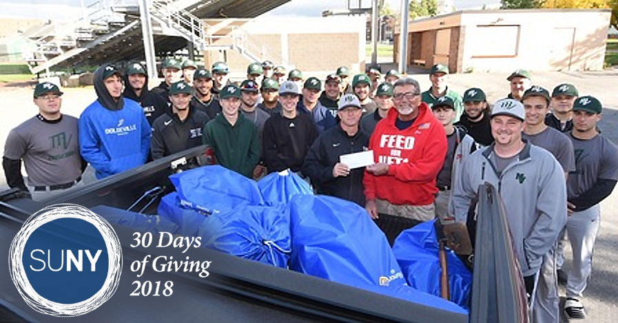 Mohawk Valley Community College baseball team members stand outside with bags of donated goods for local veterans.