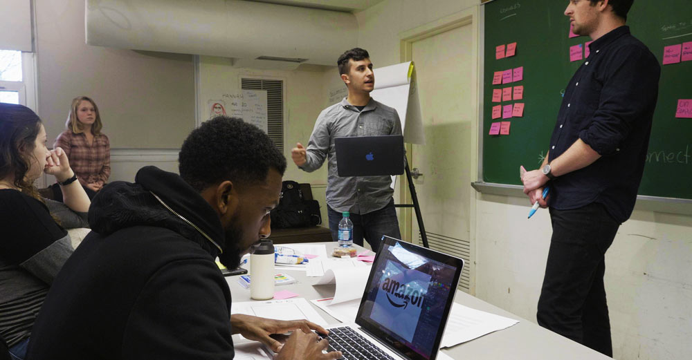 Farmingdale State students work in a classroom on the Amazon Design Challenge.