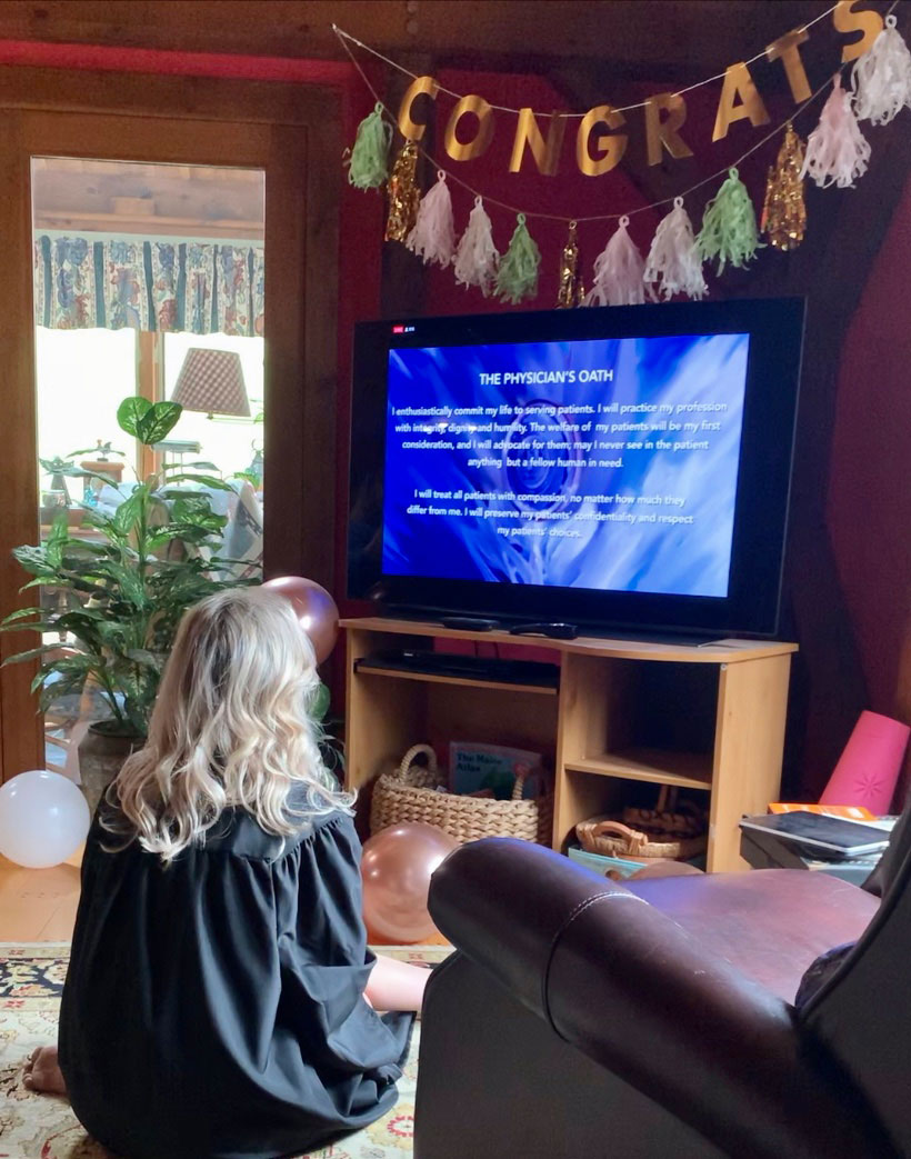 Mary Beth Gadarowski watches the physician's oath during her virtual commencement from SUNY Upstate Medical University
