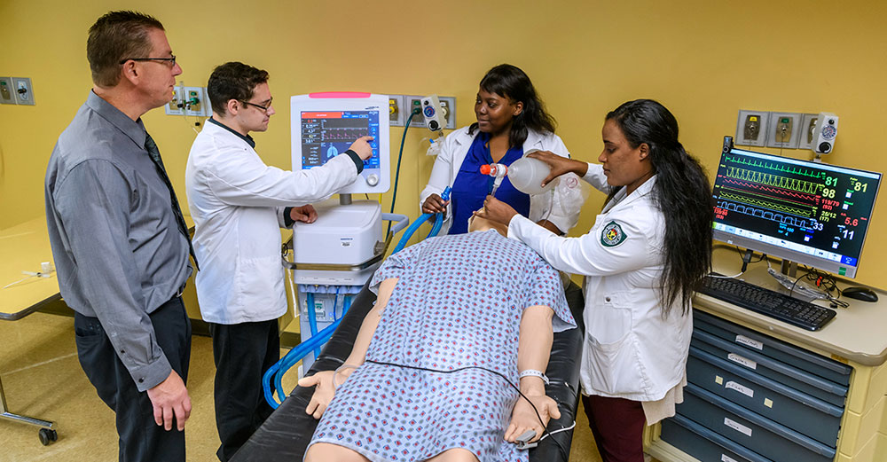 Respiratory Therapy students work on a dummy body to learn proper treatment techniques.