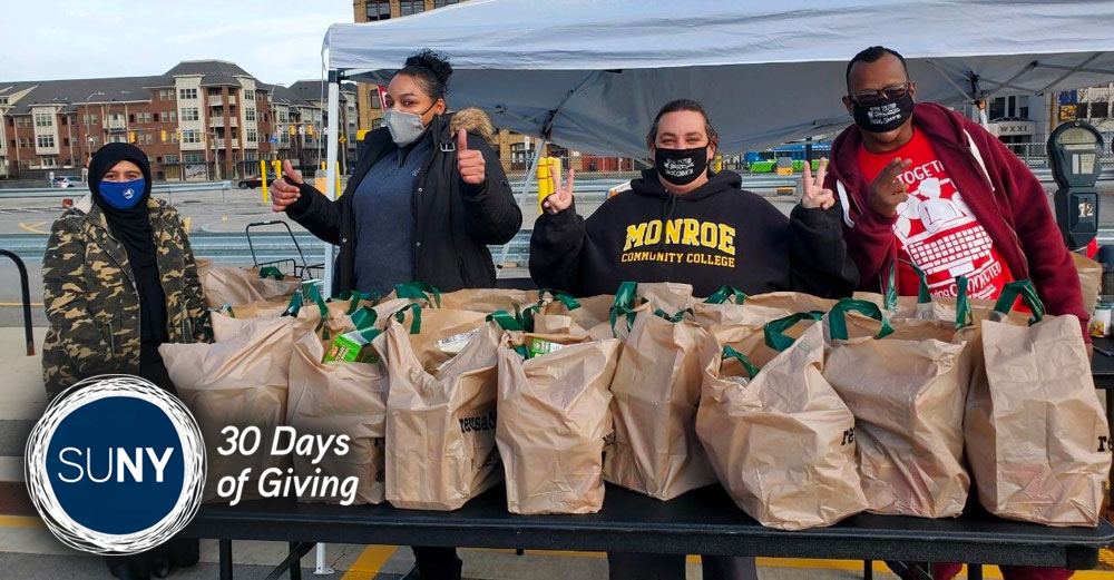 Students and staff from Monroe Community College distribute meal kits at Turkey Drop at Downtown Campus