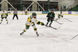 Simone Bednarik takes a slapshot in a hockey game at SUNY Oswego.