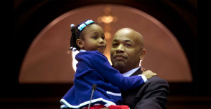 Assemblyman Carl Heastie, Stony Brook Alumnus, stands with his daughter after being named Speaker of the NYS Assembly. (Photo courtesy AP/Mike Groll)
