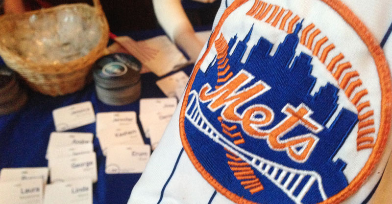 Sleeve of Mets jersey with Mets patch overlooking table with nametags.