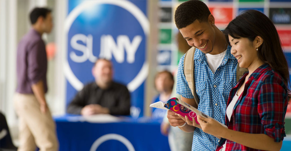Students at a SUNY College Fair looking at SUNY Viewbook