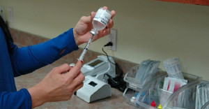 vaccine being filled from bottle to needle