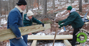 SUNY Delhi students prepare wood to build a house with Habitat for Humanity.
