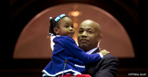 Assemblyman Carl Heastie, Stony Brook Alumnus, stands with his daughter after being named Speaker of the NYS Assembly. (Photo courtesy AP/Mike Groll)