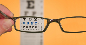 Nearsighted eye exam with letters eye chart through glasses.