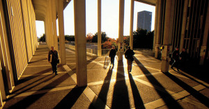 Students walking on the University at Albany campus at twilight.