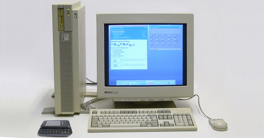 An old desktop computer and old slider cell phone