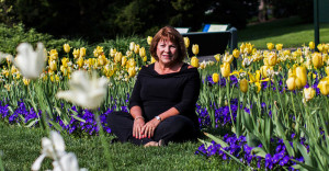 Elizabeth Mazes sits in the grass at the New York Botanical Garden in the Bronx. Photo courtesy Christopher Gregory for The New York Times.