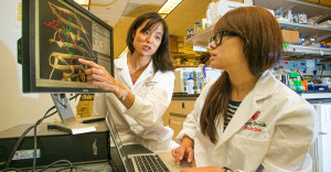 Two asian female researchers conducting TB research at StonyBrook.