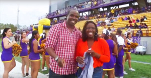 A couple smiles on the UAlbany football field after marriage proposal.