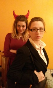 2 females dressed as the devil ad devils's lawyer for Halloween