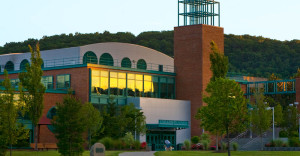 Binghamton campus buiding in front of mountain and trees.