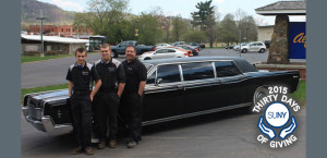3 students at Alfred State stand in front of a limousine before ELK charity challenge.