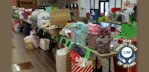 Oneonta Giving Tree event with gifts on tables.