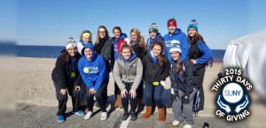 Suffolk County COmmunity College softball players pose on beach before polar plunge.