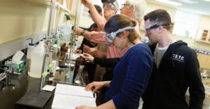 Adirondack Community College students wearing goggles in science lab.