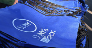 SUNY's Got Your Back bags on a table outdoors at The Barclays event.