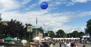 A giant blue SUNY balloon floats above attendees at the 2015 New York State Fair