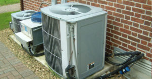 Home air conditioning unit outside a house.